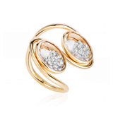 The Oito Ring by Moritz Glik with 1.0ct of diamonds enclosed in two parallel, oval Kaleidoscope Shakers™ held in a looping, continuous 18k gold band. Invoking the shape of an eight. Angled backward and to the right.