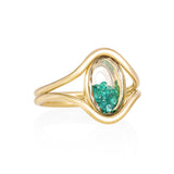 Cascavel Oval Ring Petite Emerald by Moritz Glik in 18k yellow gold with 0.23ct of emeralds enclosed in an oval-shaped Kaleidoscope Shaker on white background, facing right