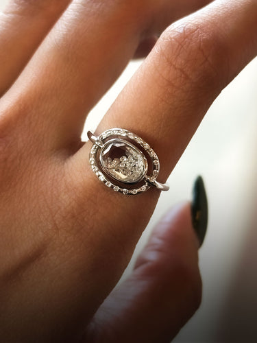 Close up of hand wearing the Elo Pave Petite Ring in 18 karat white gold and diamonds by Moritz Glik