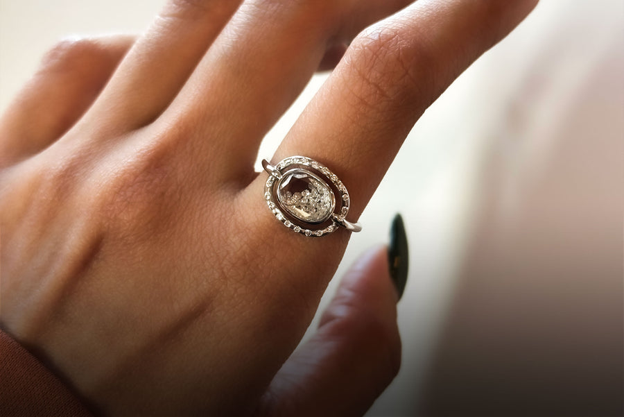 Close up of hand wearing the Elo Pave Petite Ring in 18 karat white gold and diamonds by Moritz Glik