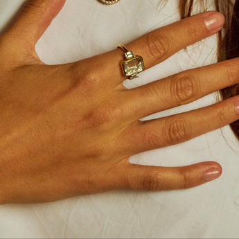 Three Stone Ring Emerald-Cut product_description_first_two_sentences - shop_name